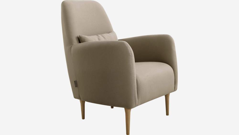 Beige fabric armchair with oak legs