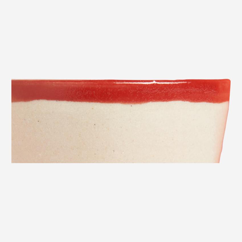 Small tumbler made in sandstone, natural and red