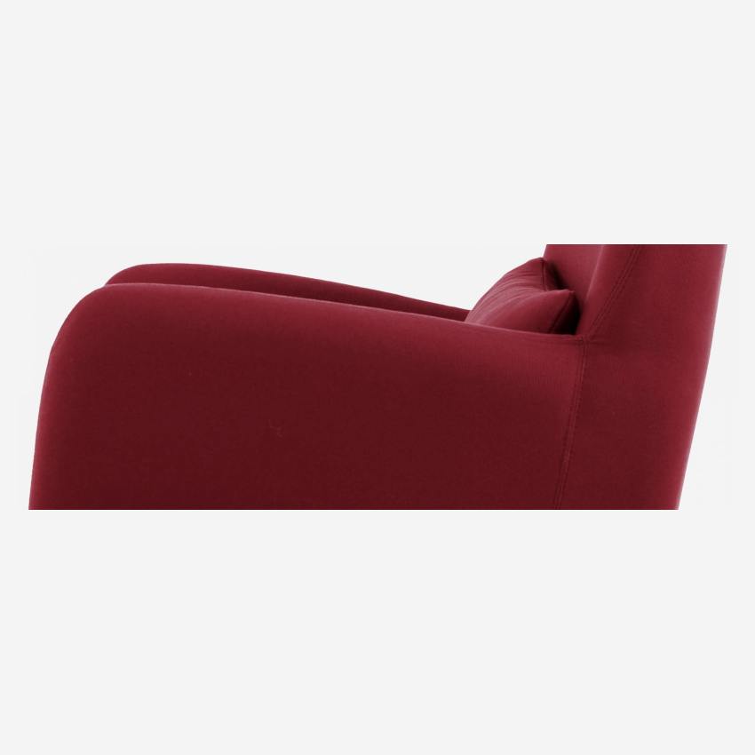 Red fabric armchair with dark legs