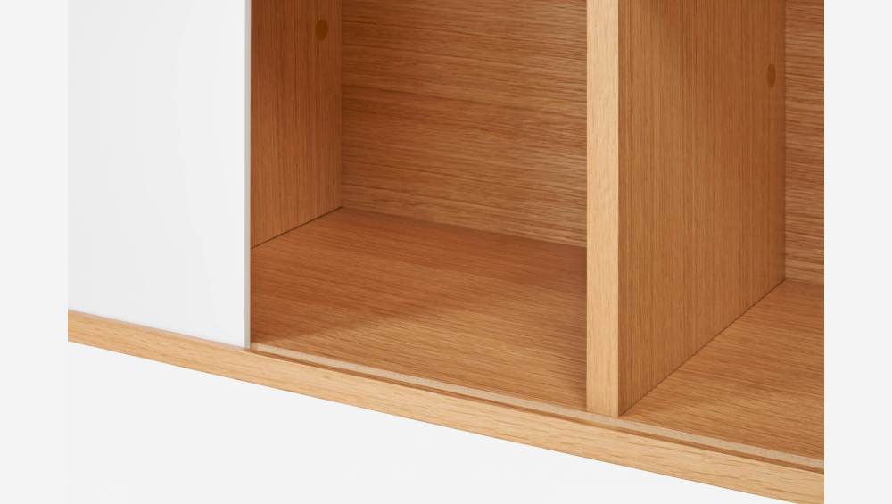 Low oak bookcase with sliding white door
