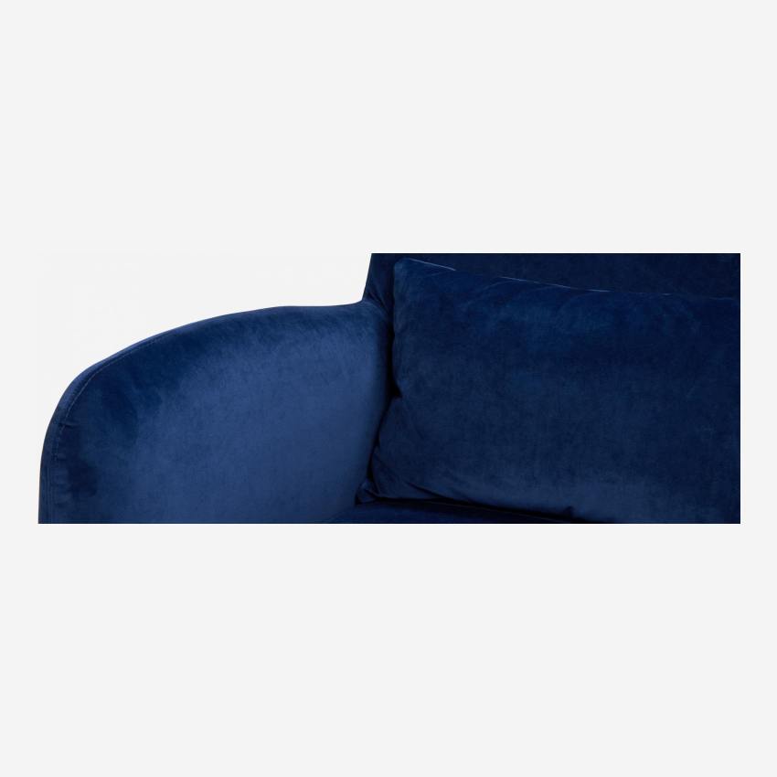 Blue velvet armchair with dark legs