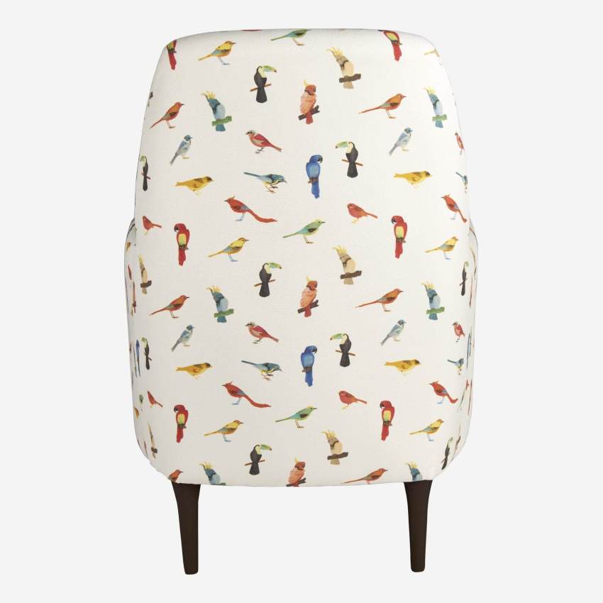 Bird motif fabric armchair with dark legs
